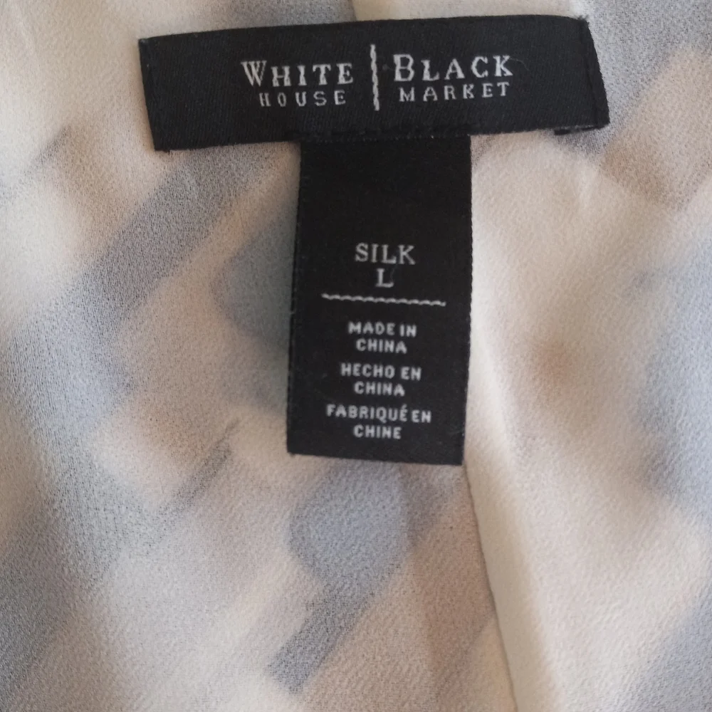 White House Black Market silk assymetrical sleeveless top with geometric…